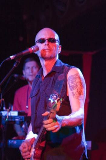 Chris Masuak performing with a guitar